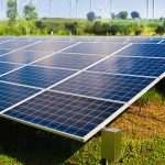 solar-panel-with-wind-turbines-against-mountains-sky